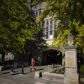 student walking through Pembroke Arch